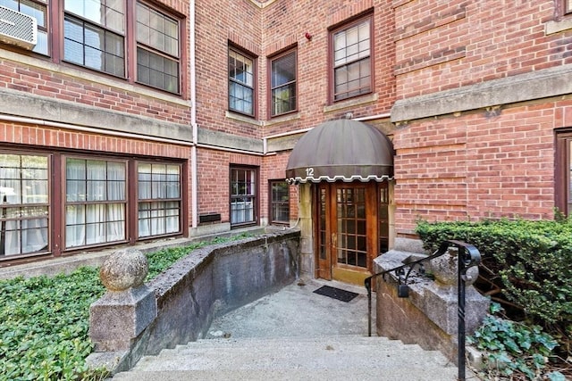 property entrance featuring brick siding