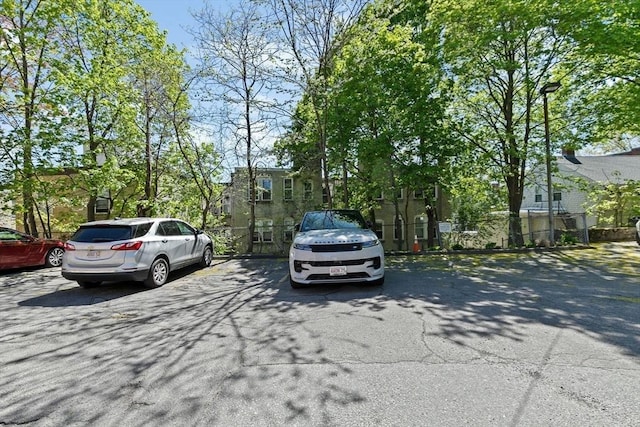 uncovered parking lot featuring fence