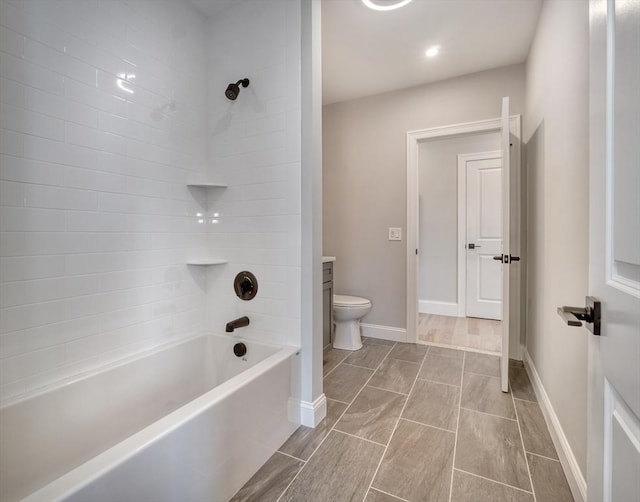 full bathroom featuring toilet, vanity, and tiled shower / bath