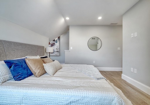 bedroom featuring wood-type flooring and lofted ceiling