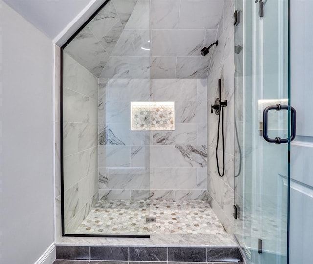 bathroom featuring a shower with shower door