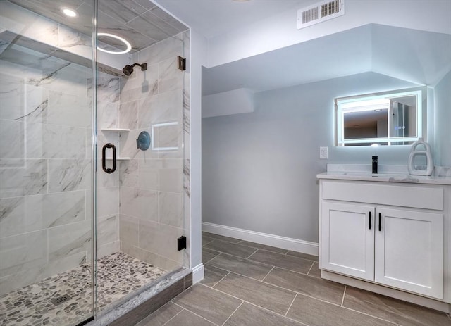 bathroom with vanity and a shower with door