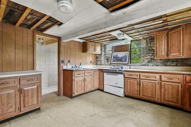 3 Cranberry Meadow Shore Rd, Charlton, MA 01507 - kitchen with electric range, light flooring, wooden walls, light countertops, and brown cabinetry