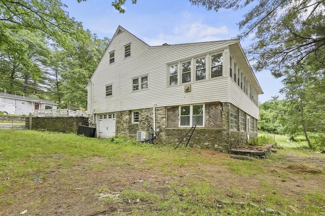 3 Cranberry Meadow Shore Rd, Charlton, MA 01507 - rear view of house with stone siding and a garage