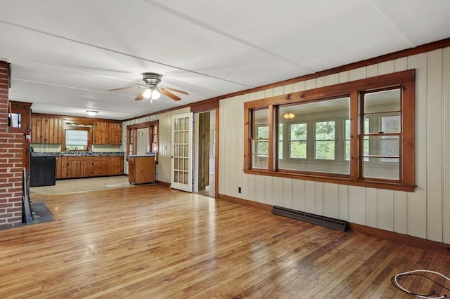 3 Cranberry Meadow Shore Rd, Charlton, MA 01507 - unfurnished living room with light wood-type flooring, a ceiling fan, wood walls, and crown molding