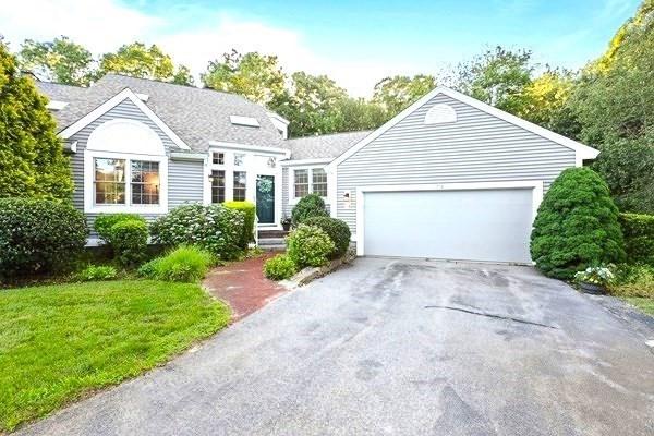74 Hidden Bay Dr Unit 74, Dartmouth, MA 02748 - view of front of house featuring an attached garage, asphalt driveway, and a front lawn