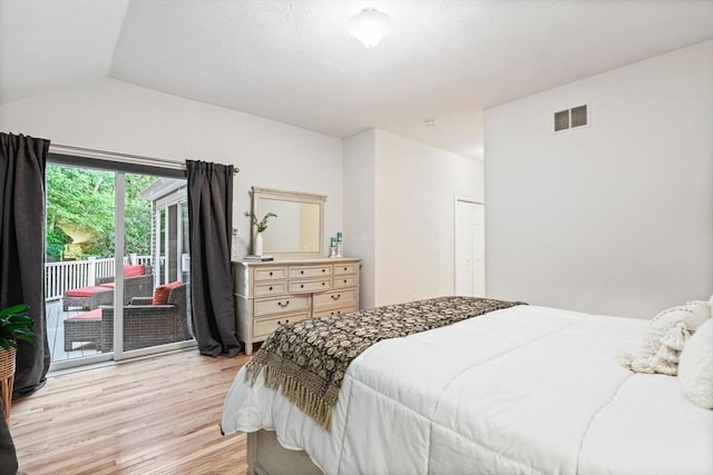 74 Hidden Bay Dr Unit 74, Dartmouth, MA 02748 - bedroom featuring access to exterior, light wood finished floors, vaulted ceiling, and a closet