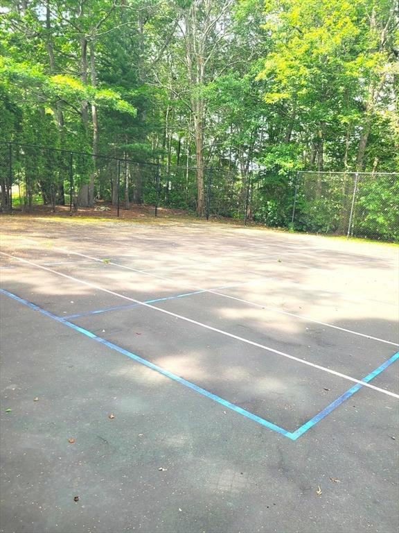 74 Hidden Bay Dr Unit 74, Dartmouth, MA 02748 - view of parking featuring community basketball court and a wooded view