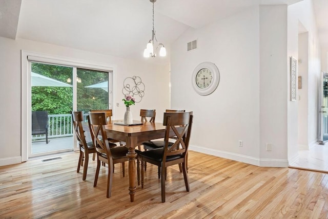74 Hidden Bay Dr Unit 74, Dartmouth, MA 02748 - dining room featuring vaulted ceiling, a chandelier, and light wood-type flooring