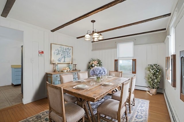 dining area with a baseboard radiator, wood-type flooring, a notable chandelier, and beamed ceiling