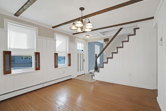 entrance foyer with a notable chandelier, beam ceiling, a baseboard radiator, and hardwood / wood-style floors