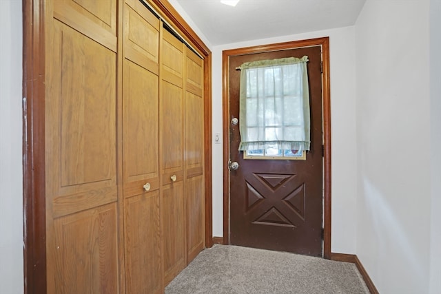 doorway with carpet flooring