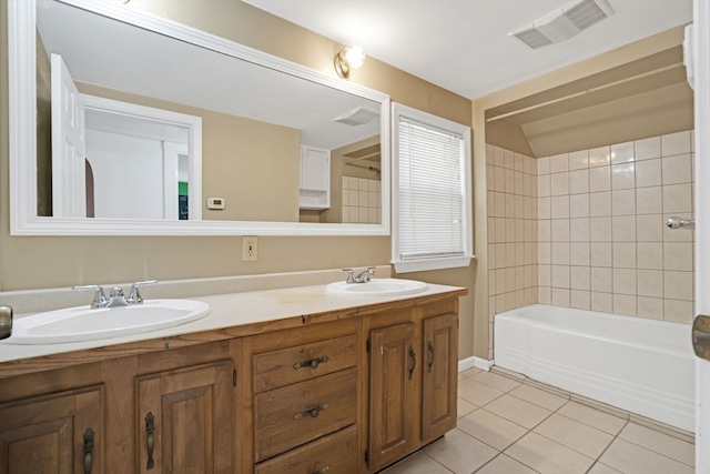 bathroom featuring tiled shower / bath, vanity, and tile patterned floors