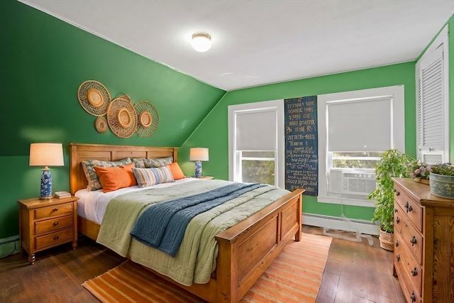 bedroom featuring vaulted ceiling, baseboard heating, and hardwood / wood-style flooring