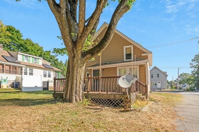 rear view of house with a lawn, a deck, and central AC unit