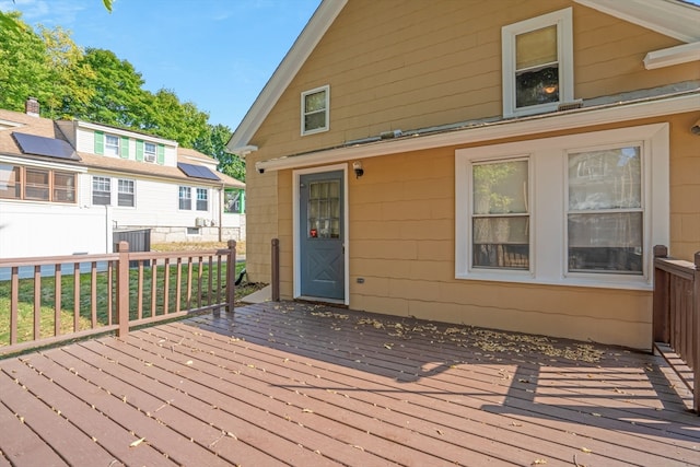 wooden deck featuring cooling unit