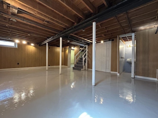 basement with wooden walls and stairs