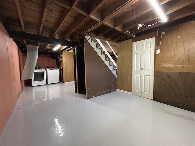 unfinished basement with stairway and washing machine and clothes dryer