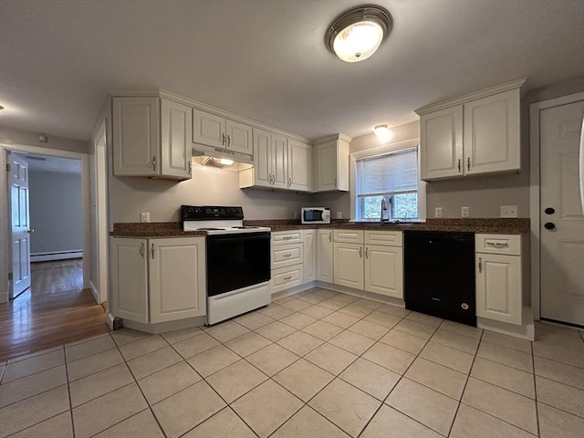 kitchen featuring white microwave, a baseboard heating unit, under cabinet range hood, dishwasher, and range with electric stovetop