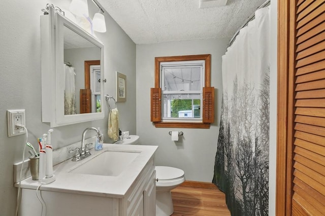 6 Batten St, Webster, MA 01570 - bathroom featuring wood finished floors, toilet, a textured ceiling, vanity, and baseboards