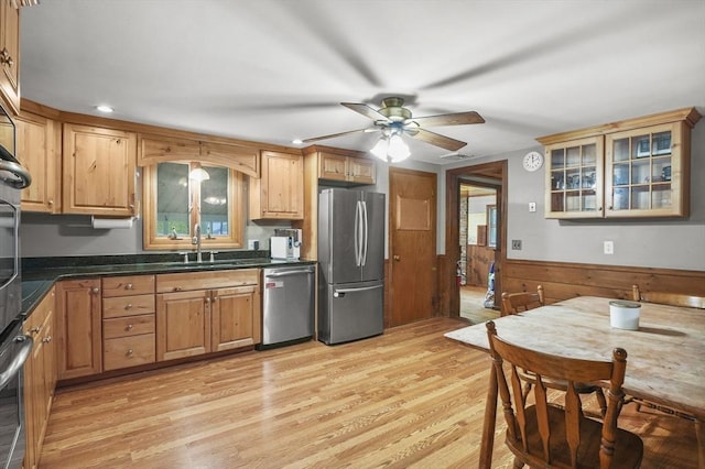 6 Batten St, Webster, MA 01570 - kitchen with stainless steel appliances, light wood finished floors, a sink, a ceiling fan, and wainscoting