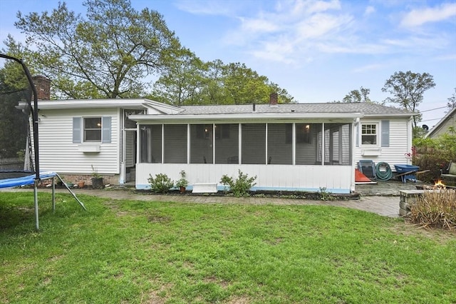 6 Batten St, Webster, MA 01570 - rear view of house with a trampoline, a sunroom, and a lawn