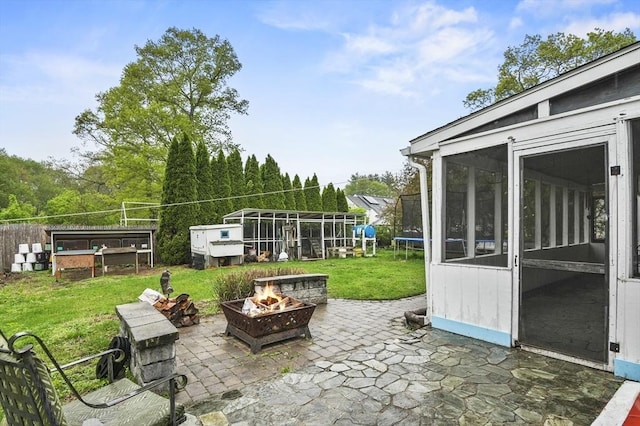 6 Batten St, Webster, MA 01570 - view of patio featuring a fire pit and a trampoline