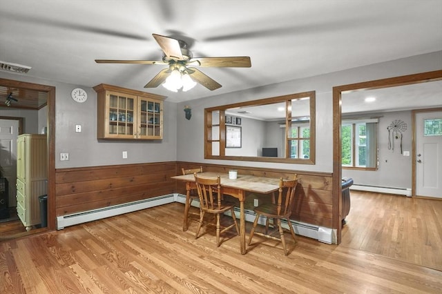6 Batten St, Webster, MA 01570 - dining room featuring a baseboard radiator, light wood-style floors, wainscoting, baseboard heating, and ceiling fan