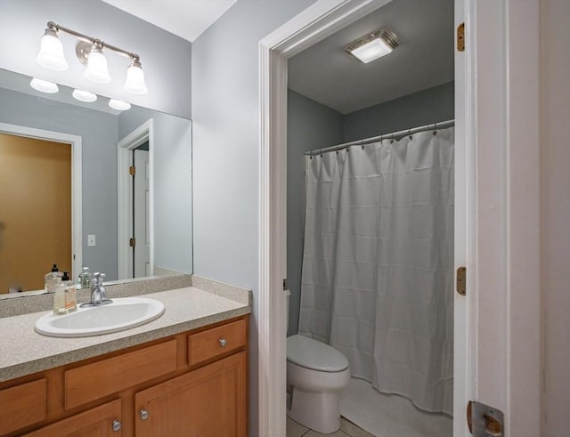 full bathroom with a shower with shower curtain, toilet, vanity, and tile patterned flooring