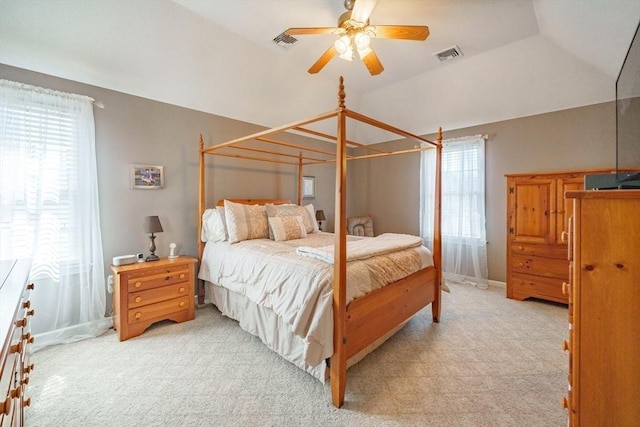 bedroom featuring visible vents, multiple windows, light colored carpet, and vaulted ceiling