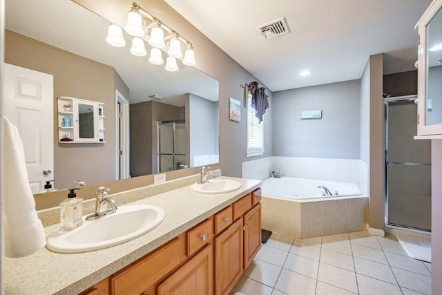 bathroom featuring tile patterned flooring, a shower stall, visible vents, and a sink