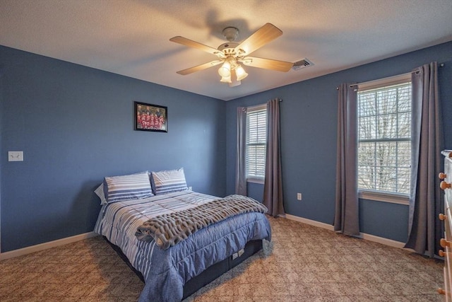 bedroom with visible vents, baseboards, a textured ceiling, and carpet flooring