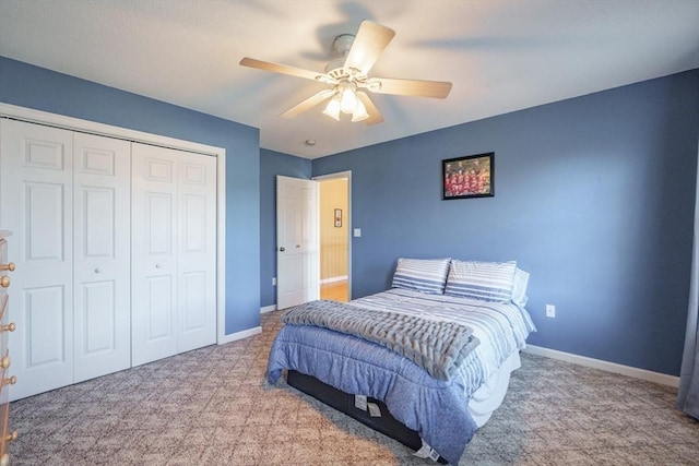 carpeted bedroom featuring a closet, baseboards, and ceiling fan