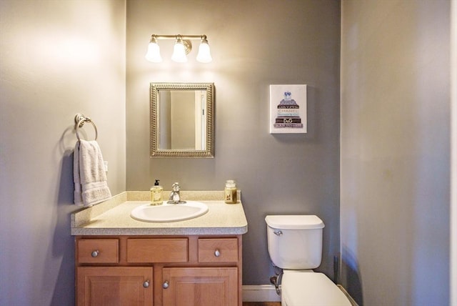 bathroom with toilet and vanity