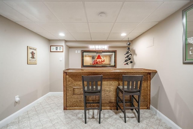 bar featuring a drop ceiling, recessed lighting, a dry bar, and baseboards