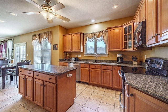 kitchen featuring a sink, stainless steel appliances, and brown cabinetry