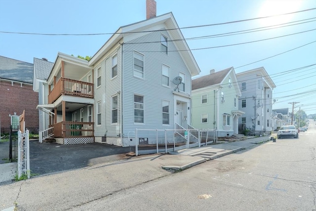 36 3rd St, Lowell, MA 01850 - view of front of home featuring a balcony and a chimney
