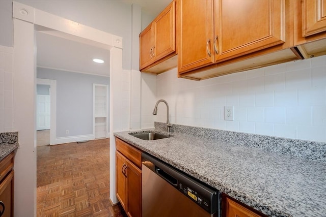 36 3rd St, Lowell, MA 01850 - kitchen featuring stainless steel dishwasher, light stone countertops, backsplash, crown molding, and brown cabinetry