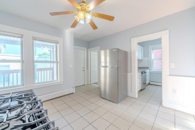 36 3rd St, Lowell, MA 01850 - kitchen with appliances with stainless steel finishes, plenty of natural light, a ceiling fan, wainscoting, and light tile patterned floors