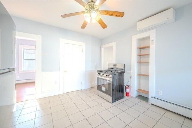 36 3rd St, Lowell, MA 01850 - kitchen featuring gas range, a baseboard radiator, a wall mounted AC, freestanding refrigerator, and ceiling fan