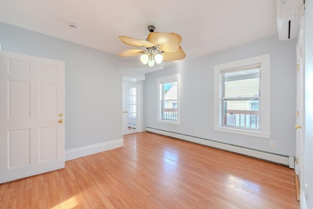 36 3rd St, Lowell, MA 01850 - empty room featuring baseboard heating, plenty of natural light, light wood-style floors, and a ceiling fan