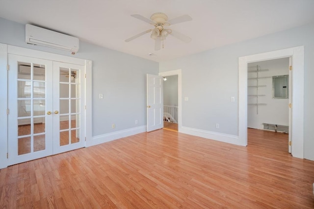 36 3rd St, Lowell, MA 01850 - unfurnished room featuring a wall unit AC, french doors, electric panel, and light wood finished floors