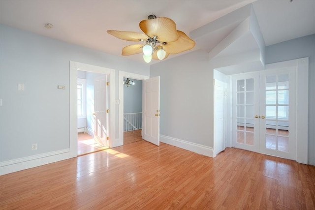 36 3rd St, Lowell, MA 01850 - empty room featuring healthy amount of natural light, light wood-style floors, french doors, and ceiling fan