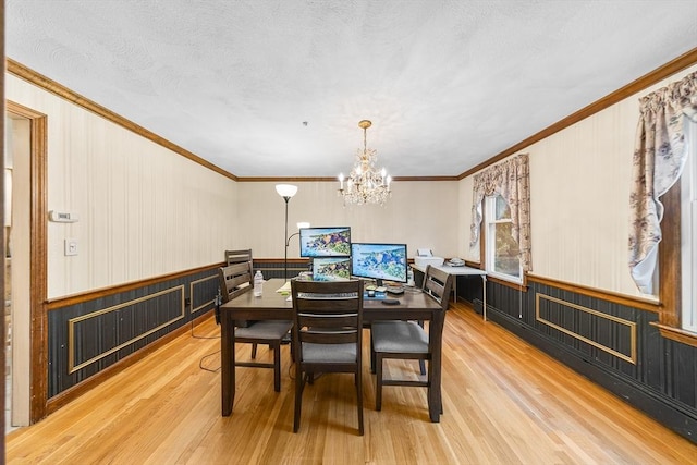 89 Gray St, North Andover, MA 01845 - dining space with wood finished floors, a chandelier, crown molding, a wainscoted wall, and wood walls