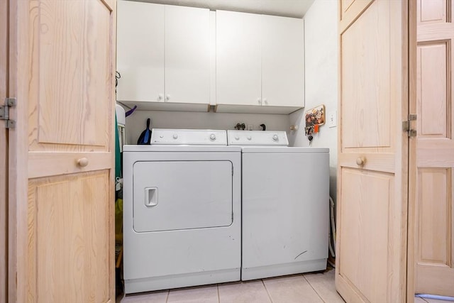 89 Gray St, North Andover, MA 01845 - washroom featuring separate washer and dryer, cabinet space, and light tile patterned flooring
