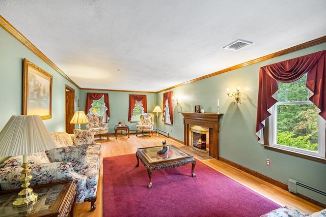 89 Gray St, North Andover, MA 01845 - living area with a baseboard radiator, crown molding, wood finished floors, and a fireplace with flush hearth