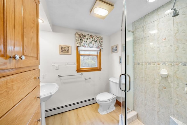 89 Gray St, North Andover, MA 01845 - bathroom with a baseboard radiator, wood finished floors, and a shower stall