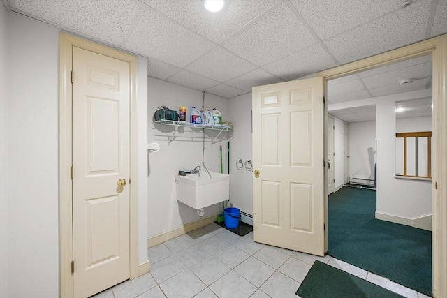89 Gray St, North Andover, MA 01845 - laundry area with light tile patterned floors and a baseboard radiator