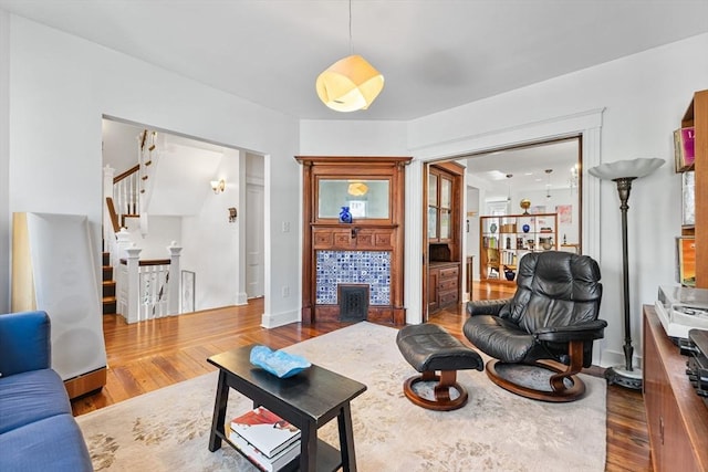 living area featuring stairway and dark wood-type flooring