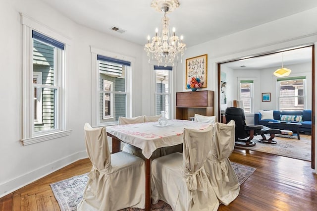 dining space with a chandelier, visible vents, and a healthy amount of sunlight